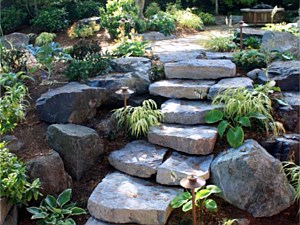 View of stone risers looking up toward fire pit patio